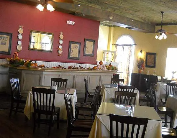 The Seminole Inn Indiantown: The dining room with hardwood floors and pecky cypress ceiling is called the Windsor Room.