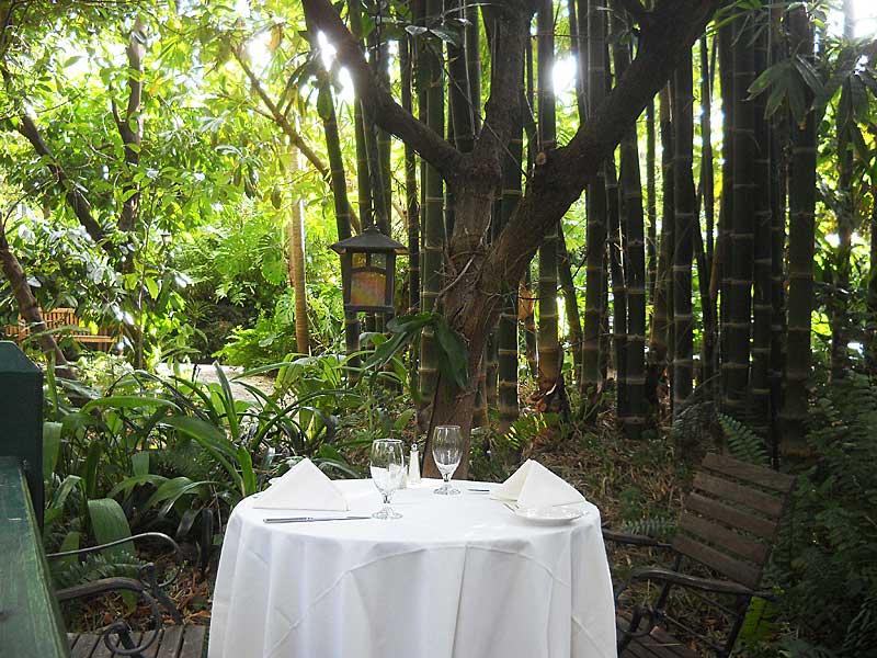 Things to do in Delray Beach: Restaurant tables situated in the gardens at the historic Sundy House in Delray Beach. The historic inn is a popular place for Sunday brunch, dinners and, at this table, marriage proposals. (Photo: Bonnie Gross)