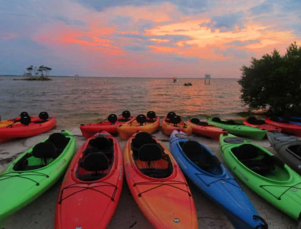 As the sun sets over Merritt Island National Wildlife Refuge, kayaks are lined up ready to launch for a bioluminescent kayak trip. (Photo: Bonnie Gross)