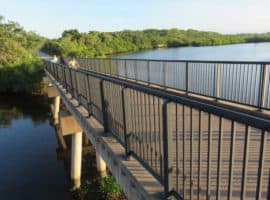 Long bicycle bridge over water.
