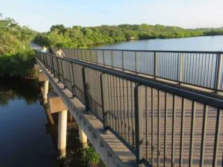 Long bicycle bridge over water.