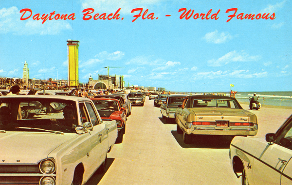 Cars of the 1970s driving on the beach on Daytona Beach. 
