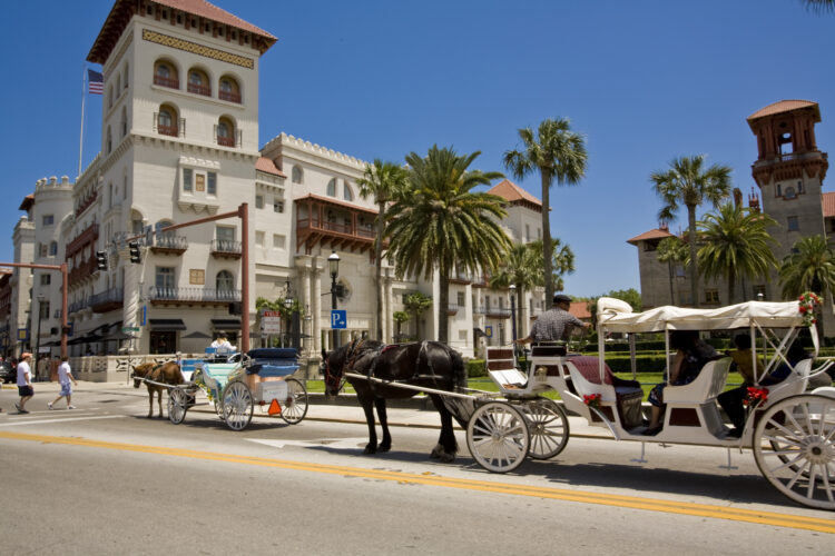 Carriages on King Street with Casa Monica in the background. The Casa Monica opened in 1888.