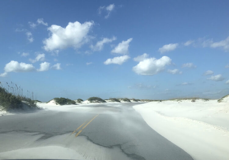 On a windy October day, Highway 399 through the Opal Beach section of Gulf Islands National Seashore looked like the road was lined with snow drifts. (Photo Bonnie Gross)