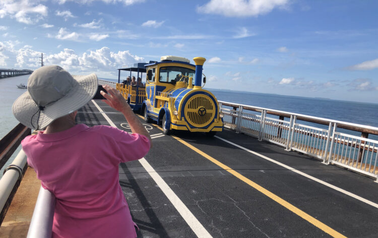 A tram decorated to look like an old-fashioned train carries visitors along the Old Seven Mile Bridge to take a tour of Pigeon Key. (Photo: David Blasco)