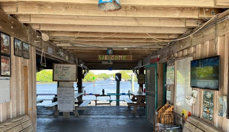 Take a perfect trip to Everglades City 14 City Seafood has a casual open air dining room with picnic tables overlooking the passing boat parade on the Barron River. It's popular for stone crabs and other fresh seafood. (Photo: Bonnie Gross)