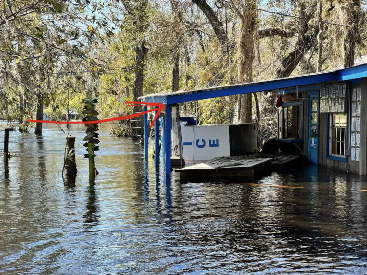Canoe Outpost Peace River was severely flooded after Hurricane Ian. The red arrow shows how high the water reached on the outfitter's office. (Photo courtesy Canoe Outpost Peace River.)