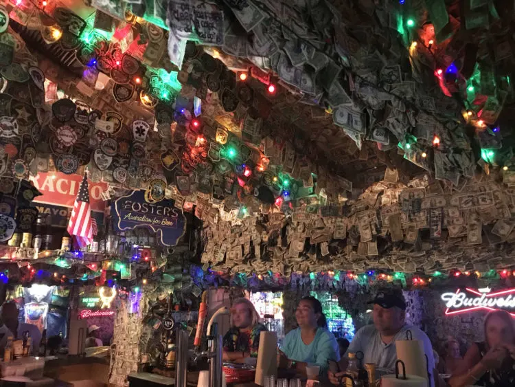 Inside No Name Pub: Dollar Bills line the ceiling and walls. (Photo: David Blasco)