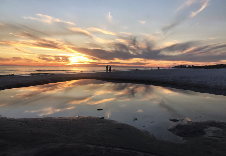 Sunset on the beach at Topsail Preserve State Park. The pool of water beachside is part of the outfall from one of the rare coastal dune lakes. (Photo: Bonnie Gross.)